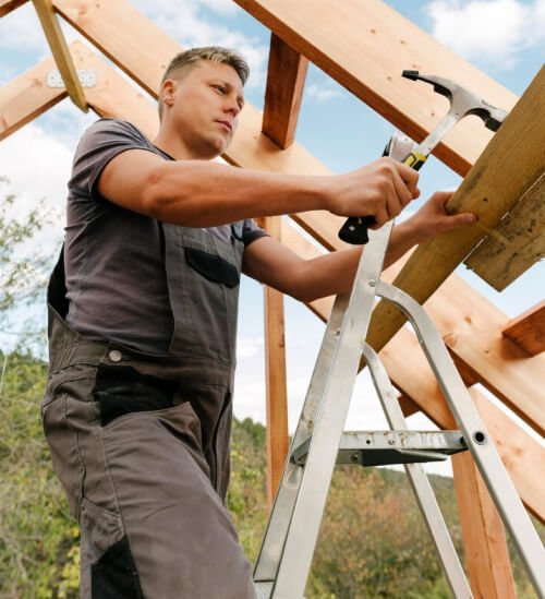 Roofing technician installing wooden framework on a residential roof in Cincinnati